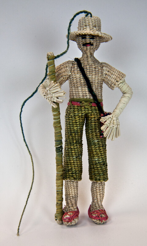 Ecuador Man Made with Woven Straw Wearing Hat and Holding Pole (Full View)