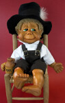 Florida Naber Kids Doll Gilbert Sitting on Chair Wearing Large Black Felt Hat (Full View)