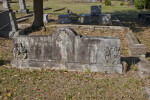 Flowers and a Celtic Cross on a Shared Headstone