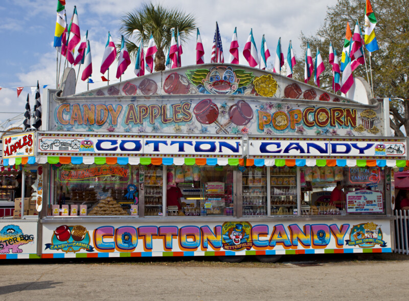 Food Stand Selling Cotton Candy, Candy Apples, & Popcorn