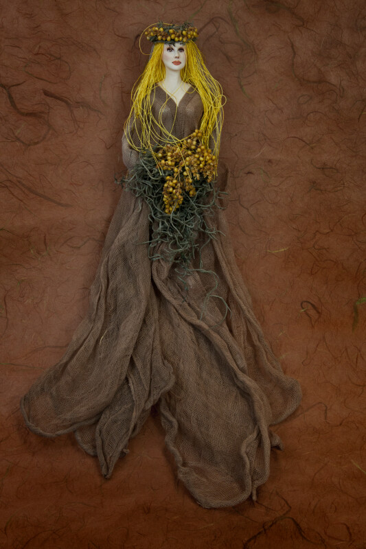 Greece Goddess of Earth Wearing Flowing Earth tone Dress and Wreath (Full View)
