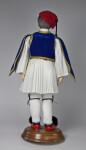 Greece Male Doll Made from Ceramic with Red Hat, Red Shoes, and Traditional Costume of Vest and Pleated Skirt (Back View)