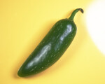Green Chili Pepper Against Yellow Background