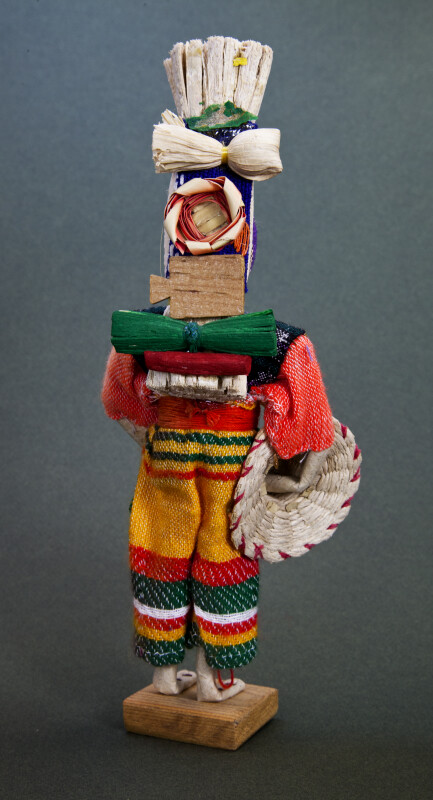 Honduras Man Wearing Bright Woven Clothes and Carrying Supplies on His Back (Back View)