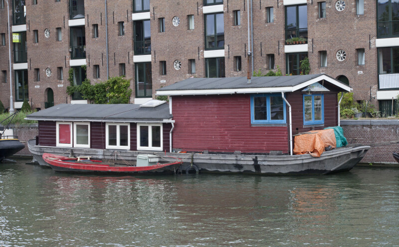 Houseboat Moored on Side of Canal in Amsterdam