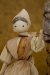 Iowa Corn Husk Doll Sitting on Wood Bench (Close Up)