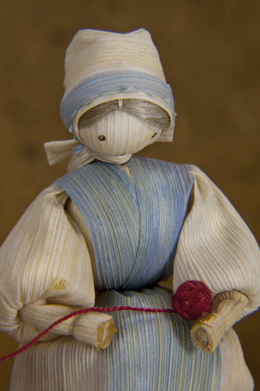 Iowa Female Doll Made from Corn Husks Holding a Ball of Yarn (Close Up)