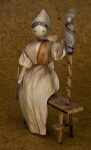 Iowa Woman Made with Corn Husks Sitting on Bench with Spindle (Three Quarter View)