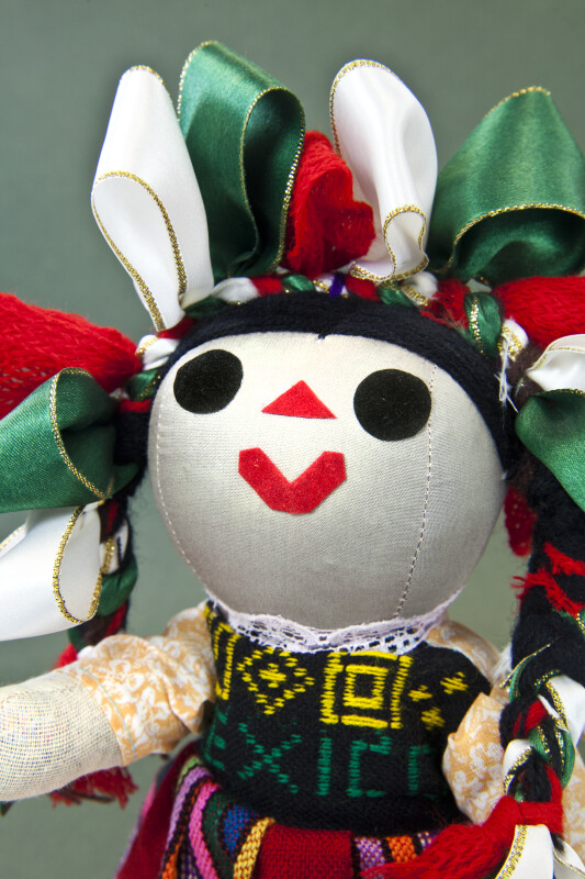 Mexico Cloth Doll with Felt Pieces for Facial Features and Colorful Ribbons in Her Hair (Close Up)