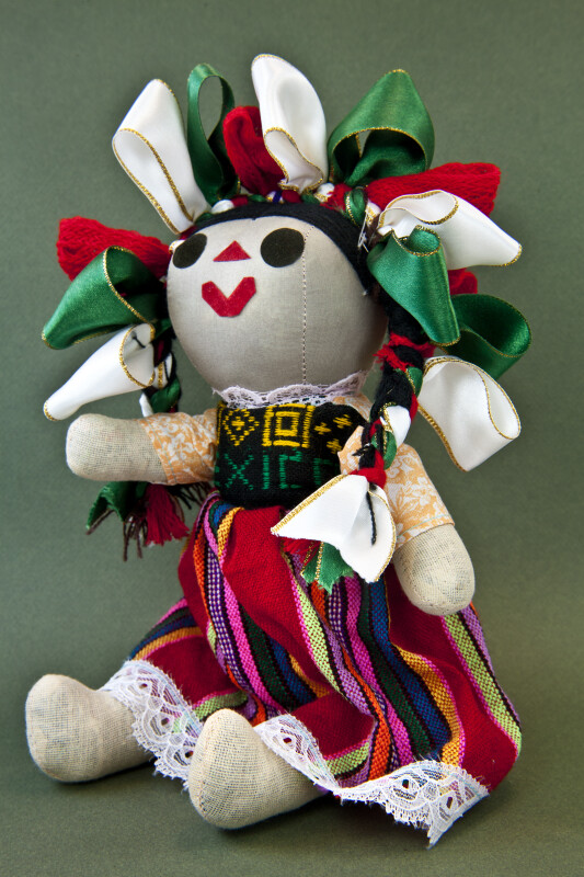 Mexico Stuffed Doll with Red Green and White Ribbons in Her Hair (Three Quarter View)