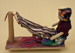New Mexico Navajo Woman Using Primitive Loom to Weave a Blanket (Profile View)