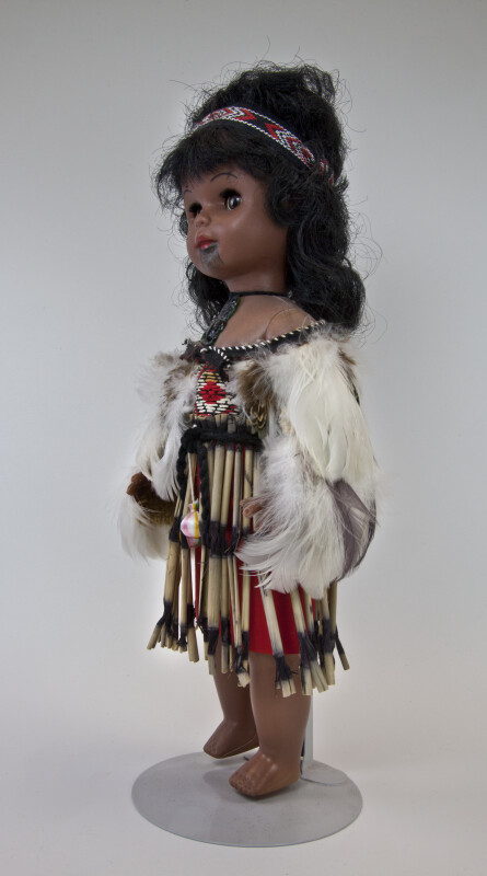 New Zealand Wahine Maori Doll Wearing Feather Cloak and Piupiu Skirt (Profile View)