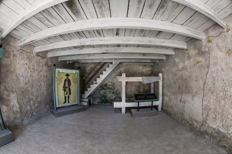 Room of the Castillo de San Marcos with Wooden Ceilings and a Staircase
