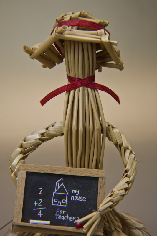 Saskatchewan, Canada - Doll Made from Wheat and Straw Holding a Chalkboard (Close Up)