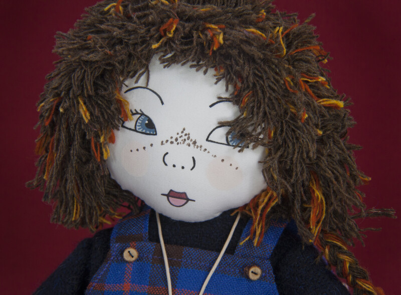 Scotland Fabric Doll with Printed Fabric Face, Yarn Hair, and Tartan Jumper (Three Quarter Close Up)