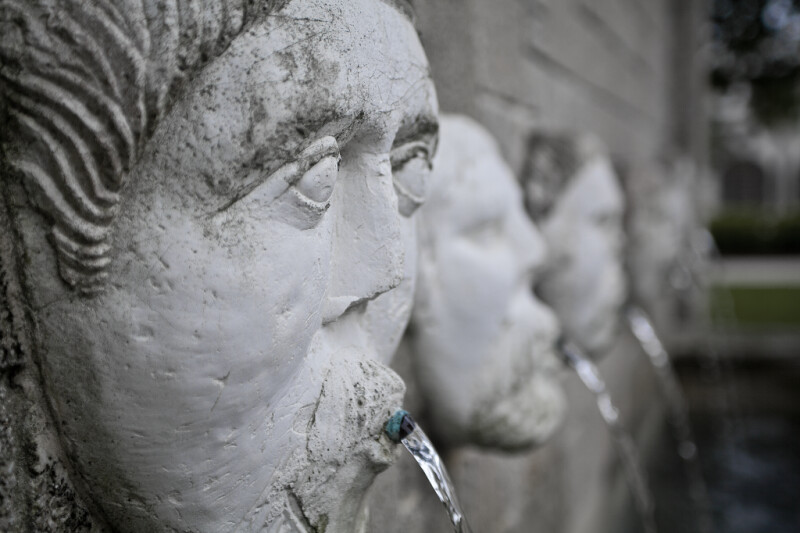 Sculpted Faces on a Masonry Wall