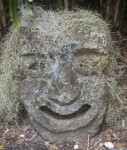 Small Sculpture of Face Covered in Spanish Moss