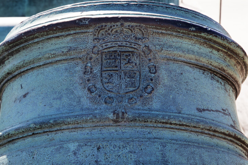 Spanish Symbols Carved Near the Barrel of an Oxidized, Bronze Mortar