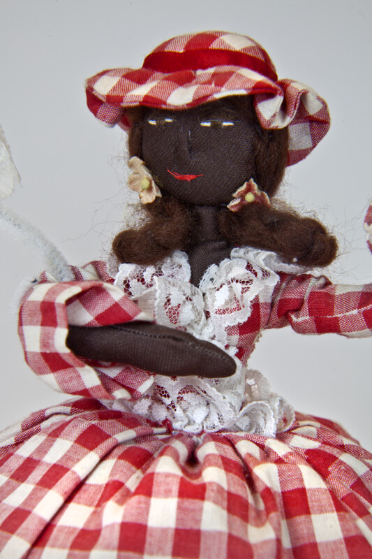 St. Maarten Stuffed Doll with Embroidered Face and Lace Parasol (Close Up)