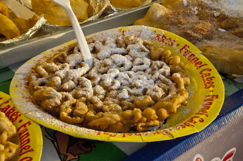 Sugary Funnel Cake on a Yellow Plate