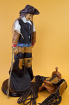 Wyoming Cowboy Wearing Leather Vest, Cuffs, Hat and Chaps (Three Quarter View)