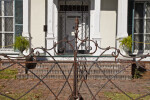 The Rusted Metal Final on the Gate outside the Curlee House