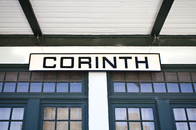 The Sign on the Exterior Wall of the Corinth Train Station