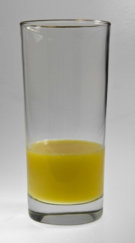 Tumbler of Orange Juice One-Quarter Full