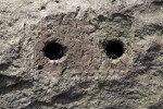 Two Bore Holes with Traces of Rusted Metal