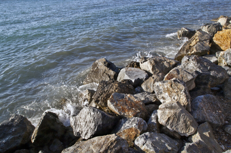 Water from the Aegean Sea Splashing Against Rocks