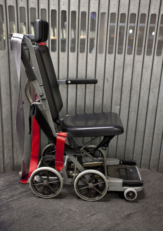 Wheelchair with Red and Gray Straps