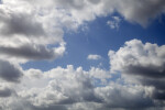White Cumulus Clouds Pictured Against a Light-Blue Sky