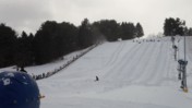 People Sliding Down a Snow-Covered Hill at Boyce Park